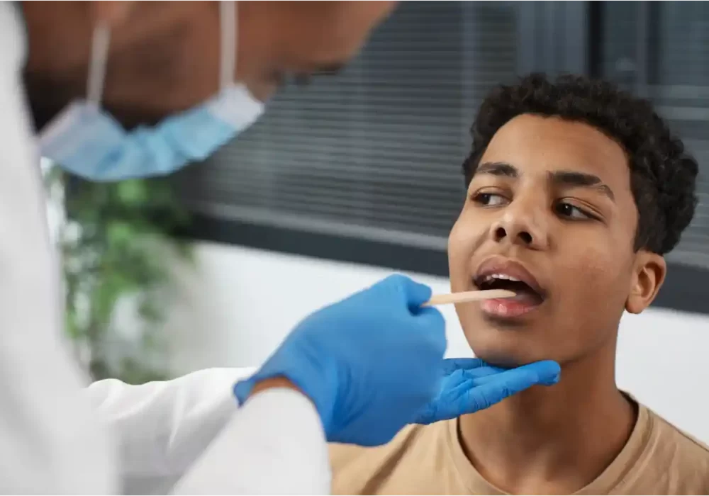 Doctor checking enlarged glands for signs of cancer or tumor